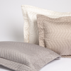 Cirillo Throw Pillow | a cluster of quilted cotton sateen throw pillows in neutral tones against a white background.