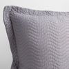 Cirillo Throw Pillow | French Lavender | a close up of a pillow corner showing the flange framing quilted cotton sateen shot against a white background.