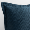 Cirillo Throw Pillow | Midnight | a close up of a pillow corner showing the flange framing quilted cotton sateen shot against a white background.