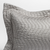 Cirillo Throw Pillow | Mineral | a close up of a pillow corner showing the flange framing quilted cotton sateen shot against a white background.