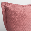 Cirillo Throw Pillow | Poppy | a close up of a pillow corner showing the flange framing quilted cotton sateen shot against a white background.