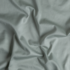 Bria Twin Flat Sheet | Eucalyptus | A close up of cotton sateen fabric in eucalyptus, a soft light green.