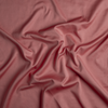Bria Twin Flat Sheet | Poppy | A close up of cotton sateen fabric in poppy, a warm coral pink.