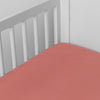 Madera Luxe Crib Sheet | Poppy | crib sheet shown on a mattress shown from overhead into the corner of a crib.