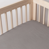 Madera Luxe Crib Sheet | French Lavender | a shot of a tencel crib sheet shot into the inside corner of a crib.
