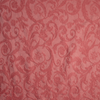 Adele Twin Coverlet | Poppy | A close up of Adele fabric in poppy, a warm coral pink.