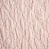 Austin Coverlet | Pearl | A close up of quilted midweight linen fabric in pearl, a nude-like, soft rose pink tone.