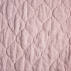 Austin Coverlet | Rouge | A close up of quilted midweight linen fabric in rouge, a mid-tone blush pink.