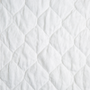 Austin Coverlet | White | A close up of quilted midweight linen fabric in classic white.