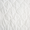 Austin Coverlet | Winter White | A close up of quilted midweight linen fabric in winter white, softer and warmer in tone than classic white.