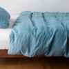 Austin Duvet Cover | Cenote | Midweight linen duvet cover in cenote on a bed, side view.