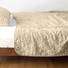 Austin Coverlet | Honeycomb | Quilted midweight linen coverlet in honeycomb on a bed - side view.