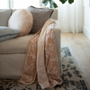 Lynette Blanket | embroidered silk velvet blanket with charmeuse trim and back in Pearl draped at end of couch.