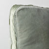Harlow Throw Pillow | Eucalyptus | Corner detail close-up of cotton velvet 24 by 24 pillow, showcasing charmeuse gusset and raw edge trim.