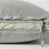 Harlow Throw Pillow | Eucalyptus | Close-up of charmeuse gusset, raw-edge trim, and brass zipper detail on Harlow pillow - side view.
