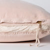 Harlow Throw Pillow | Pearl | Close-up of charmeuse gusset, raw-edge trim, and brass zipper detail on Harlow pillow - side view.