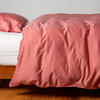 Bria Twin Duvet Cover | Poppy | duvet cover and matching sleeping pillow on white sheeting - side view.