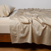 Bria Flat Sheet | Honeycomb | Cotton sateen flat sheet, shown with matching fitted sheet and sleeping pillow - side view.