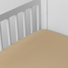 Bria Crib Sheet | Honeycomb | Cotton sateen crib sheet shown from a slight overhead angle into  an inside corner of a crib.