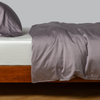 Bria Duvet Cover | French Lavender | duvet cover and matching sleep pillow on white sheeting - side view.
