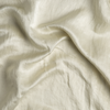 Taline Blanket | Parchment | A close up of charmeuse fabric in parchment, a warm, antiqued cream.