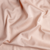 Bria Duvet Cover | Pearl | A close up of cotton sateen fabric in pearl, a nude-like, soft rose pink tone.