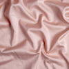 Bria Flat Sheet | Rouge | A close up of cotton sateen fabric in rouge, a mid-tone blush pink.