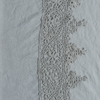 Linen Flat Sheet | Cloud | A close up of frida lace trimmed linen fabric in cloud, a soft, subtle sky blue-grey.