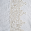 Linen Flat Sheet | White | A close up of frida lace trimmed linen fabric in classic white.
