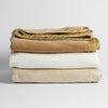 Harlow Baby Blanket | stack of three cotton velvet baby blankets in neutral tones against a white background.