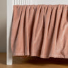 Harlow Crib Skirt | Rouge | cotton velvet crib skirt shown on a white crib .
