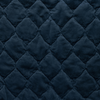 Harlow Coverlet | Midnight | A close up of quilted cotton velvet fabric in midnight, a rich indigo tone.