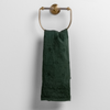 Ines Guest Towel | Juniper | embroidered midweight linen guest towel hanging from a decorative towel ring.
