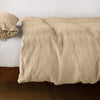 Ines Duvet Cover | Honeycomb | lightly rumpled duvet cover on a monochromatic bed against a white background - side view.