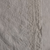 Ines Throw Pillow | Fog | A close up of embroidered midweight linen fabric in fog, a neutral-warm, soft mid-tone grey.