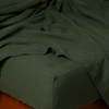 Juniper | a close up of a linen fitted sheet with matching flat sheet - corner view.