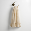 Linen Whisper Guest Towel | Parchment | guest towel draped through a decorative brass towel ring, against a white wall.