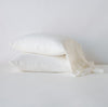 Linen Whisper Pillowcase (Single) | Winter White | Two sleeping pillows stacked at a slight angle against a plain background, showcasing ruffle trim detail - side view.