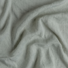 Linen Whisper Bed Skirt | Eucalyptus | A close up of linen whisper fabric in eucalyptus, a soft light green.