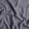 Linen Whisper Crib Skirt | French Lavender | a close up of linen whisper fabric in french lavender, a neutral violet tone.