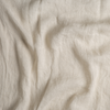 Linen Whisper Bed Skirt | Parchment | A close up of linen whisper fabric in parchment, a warm, antiqued cream.