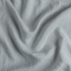 Linen Crib Skirt | Cloud | A close up of linen fabric in cloud, a soft, subtle sky blue-grey.