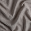 Signature Linen Swatch | Fog | A close up of linen fabric in fog, a neutral-warm, soft mid-tone grey.