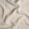 Linen Crib Skirt | Parchment | A close up of linen fabric in parchment, a warm, antiqued cream.