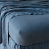 Linen Twin Fitted Sheets | Midnight | close up of fitted sheet with matching rumpled flat sheet - corner view.