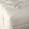 Linen Fitted Sheet | Parchment | close up of fitted sheet with matching rumpled flat sheet - corner view.
