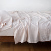 Linen Twin Fitted Sheets | Pearl | fitted sheet with matching rumpled flat sheet and sleeping pillow - side view.