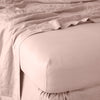 Linen Twin Fitted Sheets | Rouge | close up of fitted sheet with matching rumpled flat sheet - corner view.