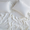 Linen Fitted Sheet | Winter White | fitted sheet with matching rumpled flat sheet and sleeping pillows - overhead view.