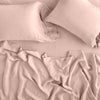 Linen Flat Sheet | Rouge | Rumpled sheeting with matching sleeping pillows - overhead view.